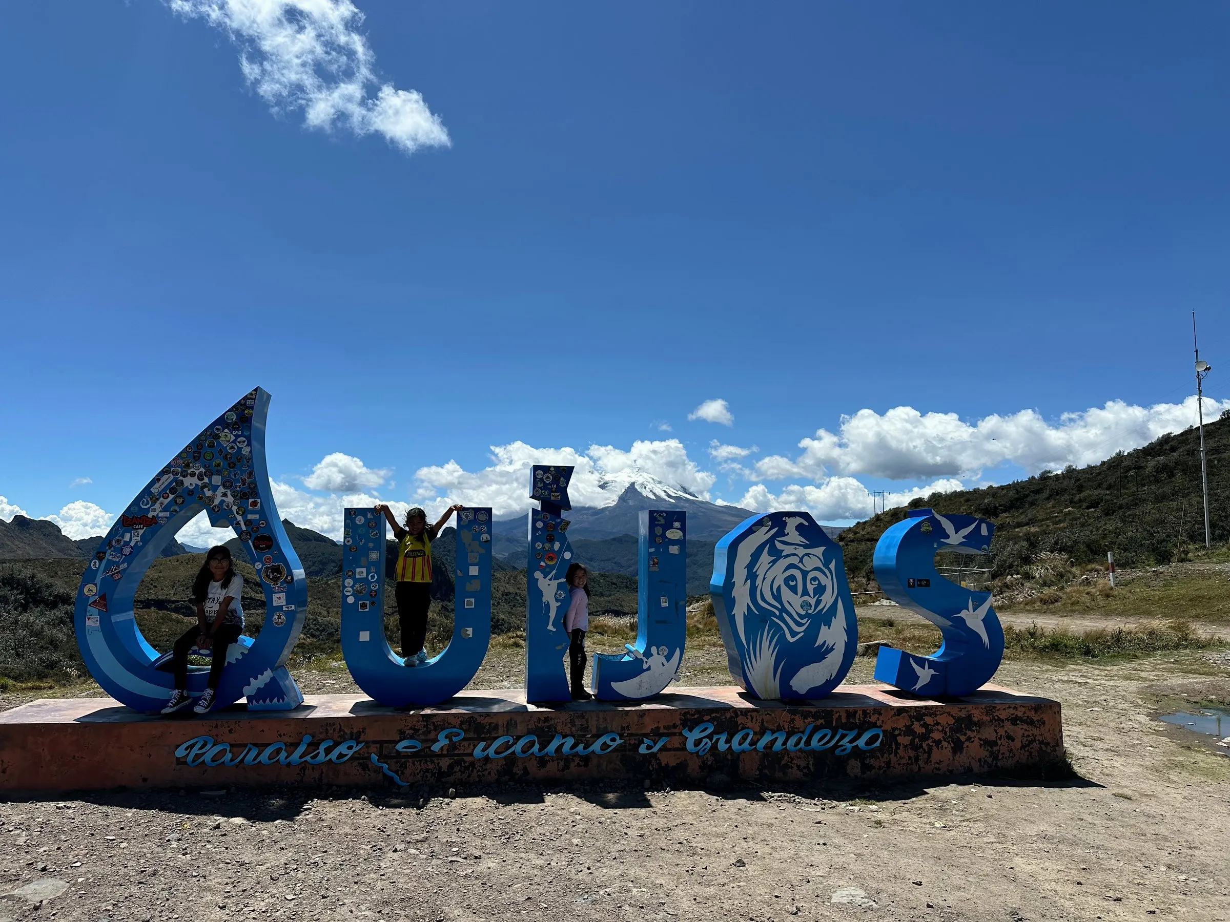 The blue Quijos welcome sign at the top of the Papallacta pass
